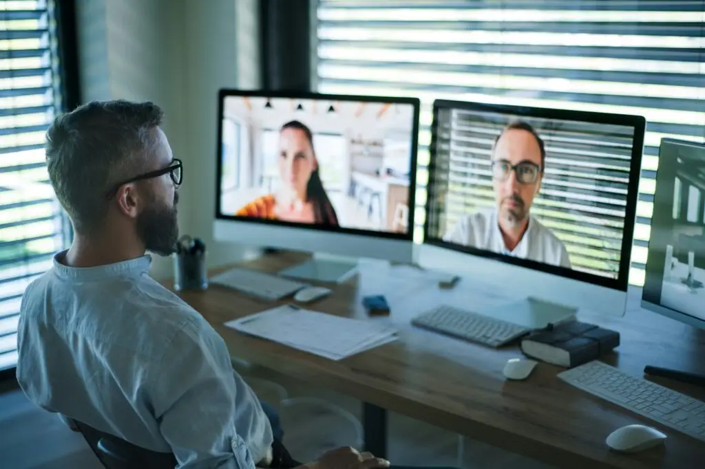 Businessman with computer sitting at desk, working. Business call concept